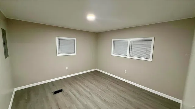 a view of a room with wooden floor and window