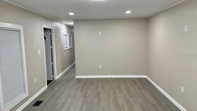 a view of hallway with wooden floor