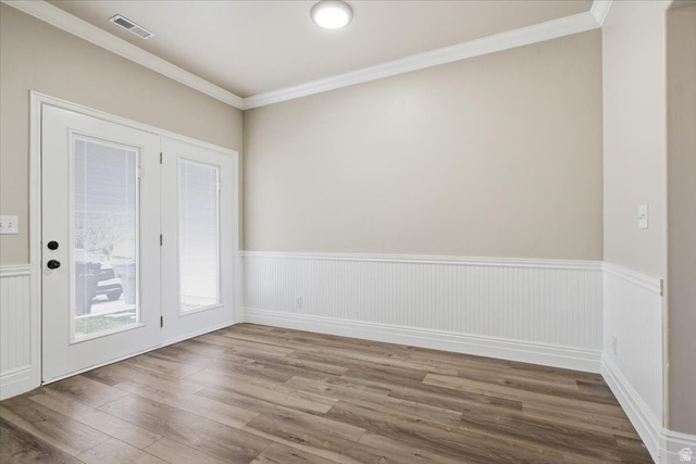 4496 West 11800 South South Jordan, UT 84009 - Photo 19 of 33 Spare room featuring crown molding, wainscoting, and dark wood-style floors