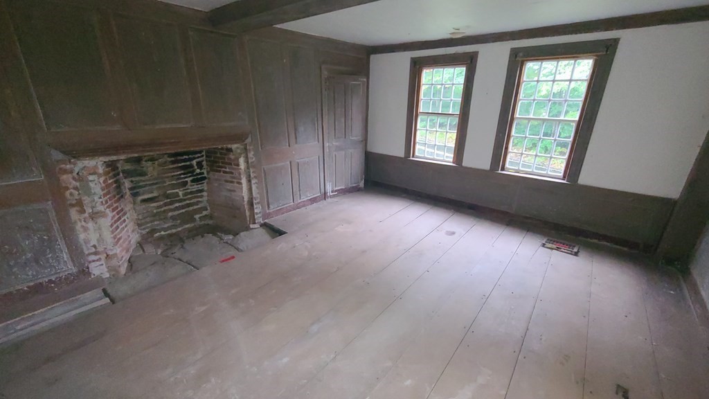 1442 Main Road Granville, MA 01034 - Photo 17 of 27 a view of an empty room with wooden floor and a window