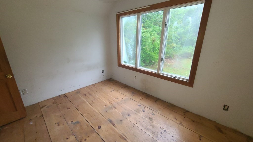 1442 Main Road Granville, MA 01034 - Photo 18 of 27 a view of empty room with wooden floor and fan