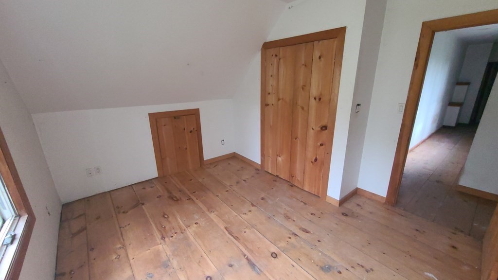 1442 Main Road Granville, MA 01034 - Photo 19 of 27 an empty room with wooden floor and closet