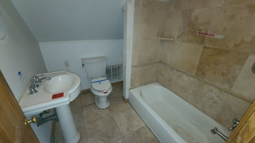 1442 Main Road Granville, MA 01034 - Photo 20 of 27 a white toilet sitting next to a bath tub