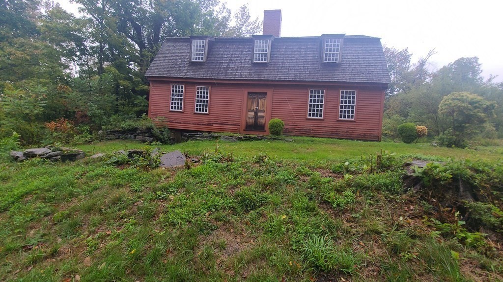 1442 Main Road Granville, MA 01034 - Photo 2 of 27 a view of a brick house with a big yard and large trees