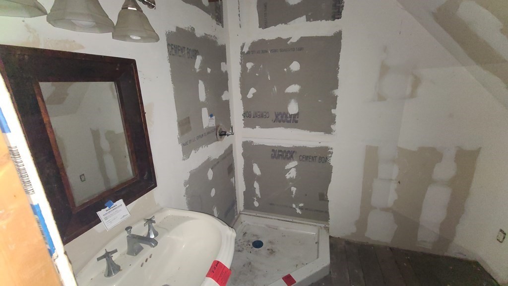 1442 Main Road Granville, MA 01034 - Photo 25 of 27 a bathroom with a sink and mirror with bathtub