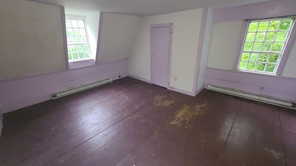 1442 Main Road Granville, MA 01034 - Photo 27 of 27 an empty room with wooden floor and windows