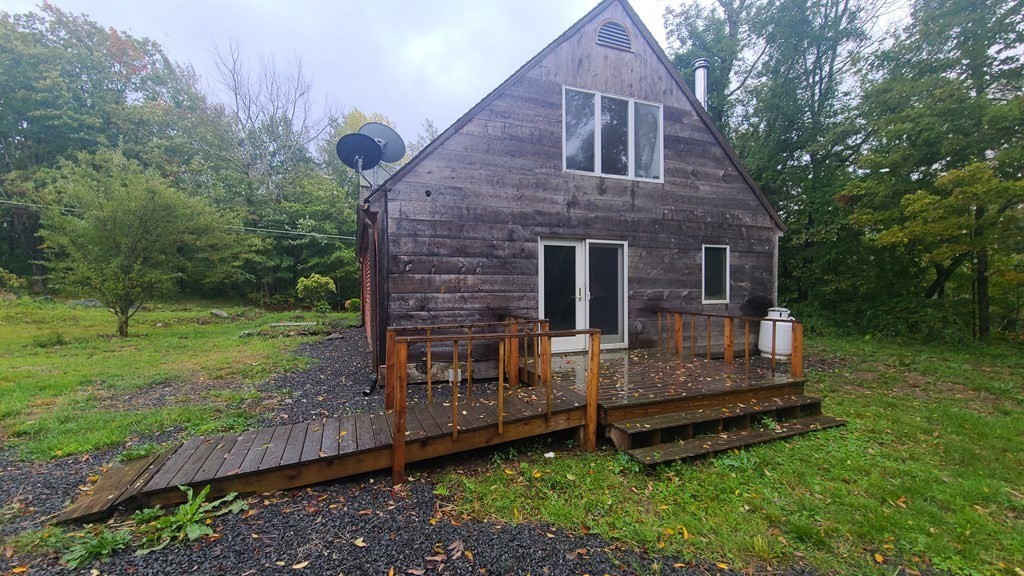 1442 Main Road Granville, MA 01034 - Photo 5 of 27 a front view of a house with a garden