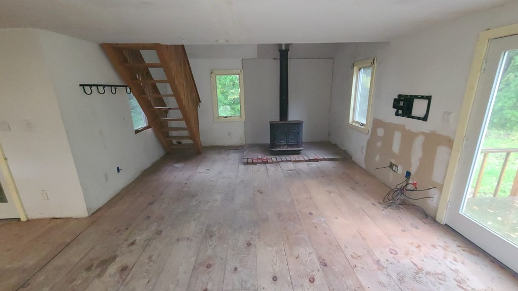 1442 Main Road Granville, MA 01034 - Photo 7 of 27 a view of an empty room with wooden floor and a window