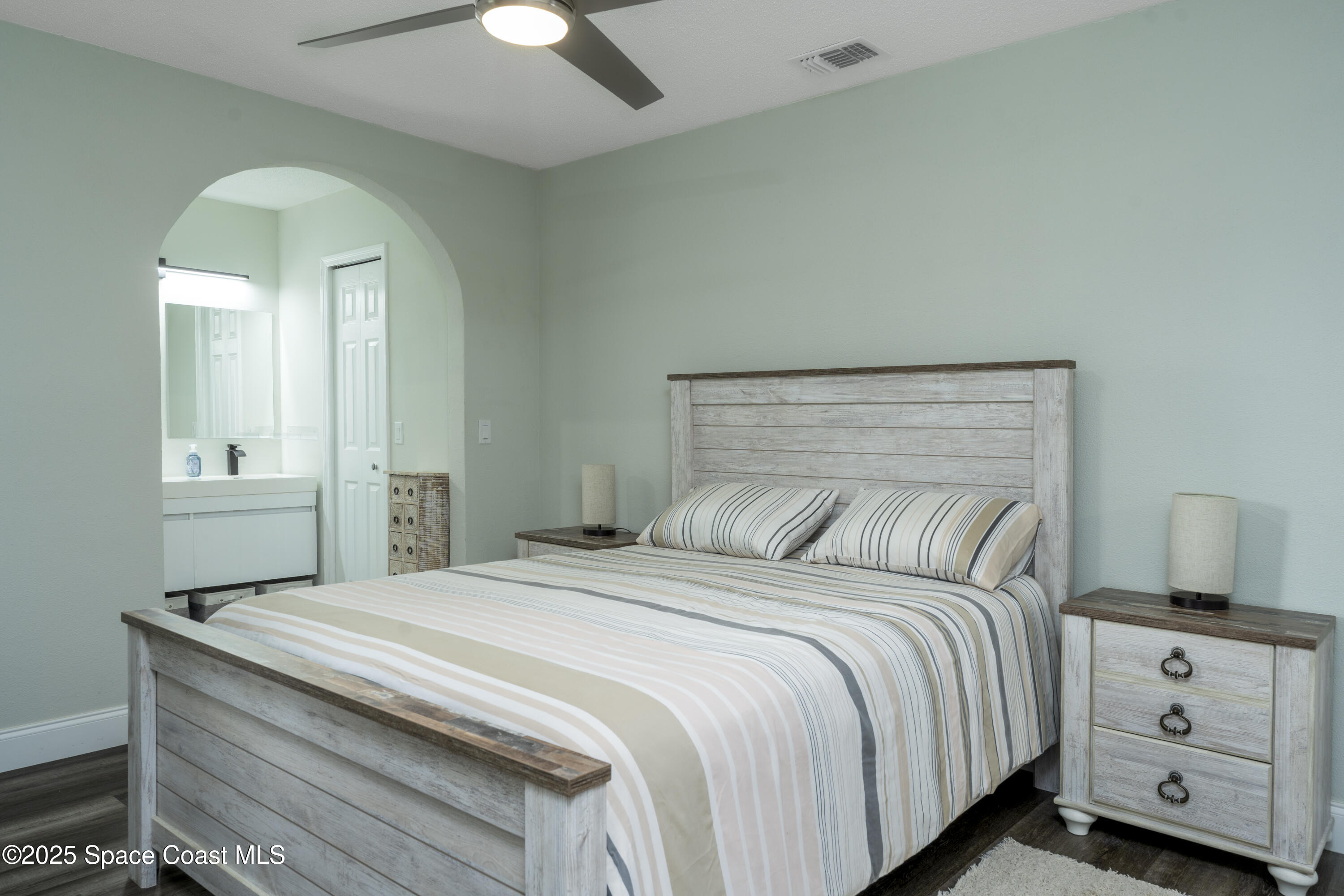 686 Hand Avenue Ormond Beach, FL 32174 - Photo 13 of 29 a bedroom with a bed and a tv