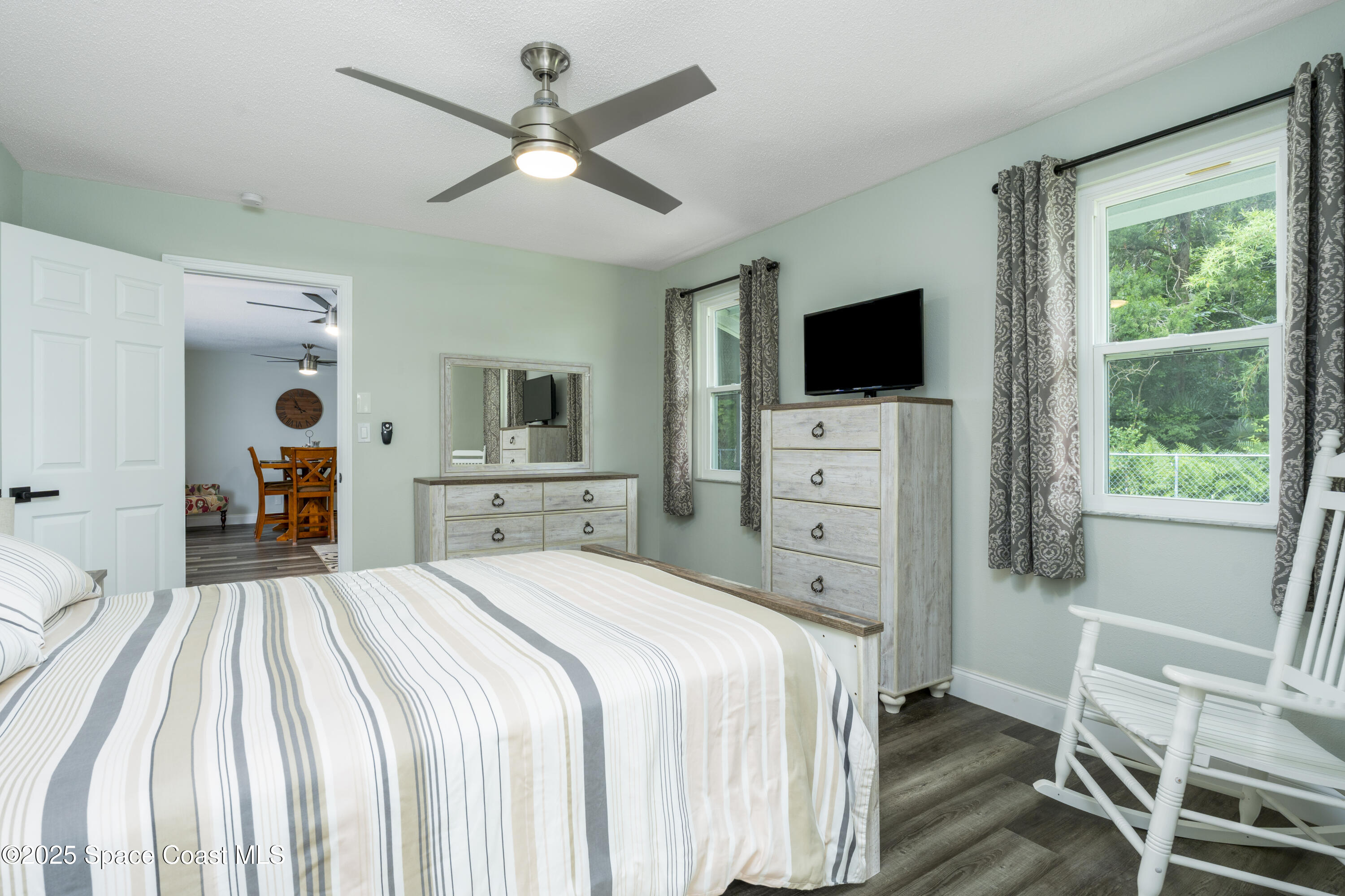 686 Hand Avenue Ormond Beach, FL 32174 - Photo 14 of 29 a bedroom with a bed and a flat screen tv