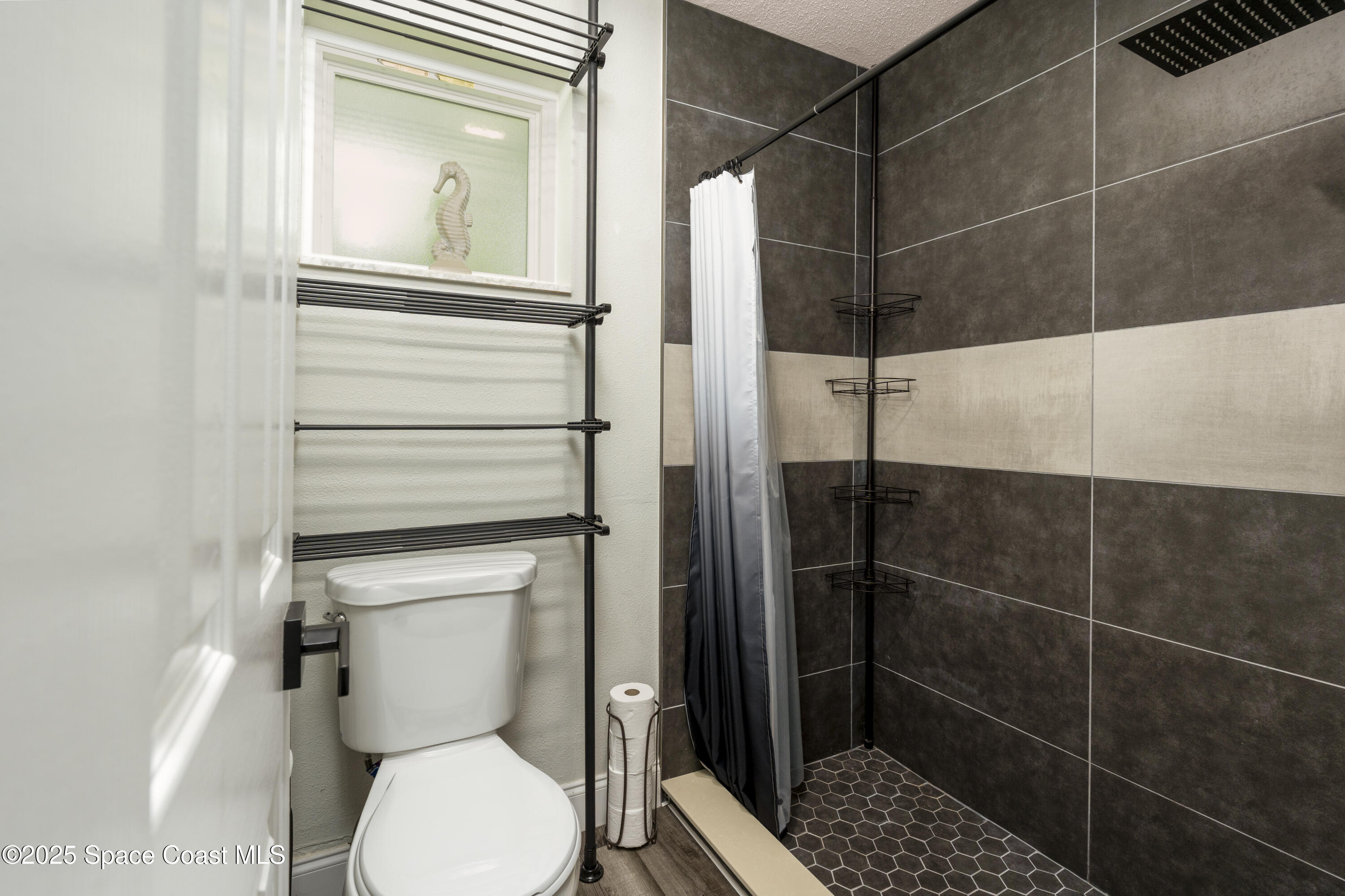 686 Hand Avenue Ormond Beach, FL 32174 - Photo 17 of 29 a bathroom with a toilet and a shower