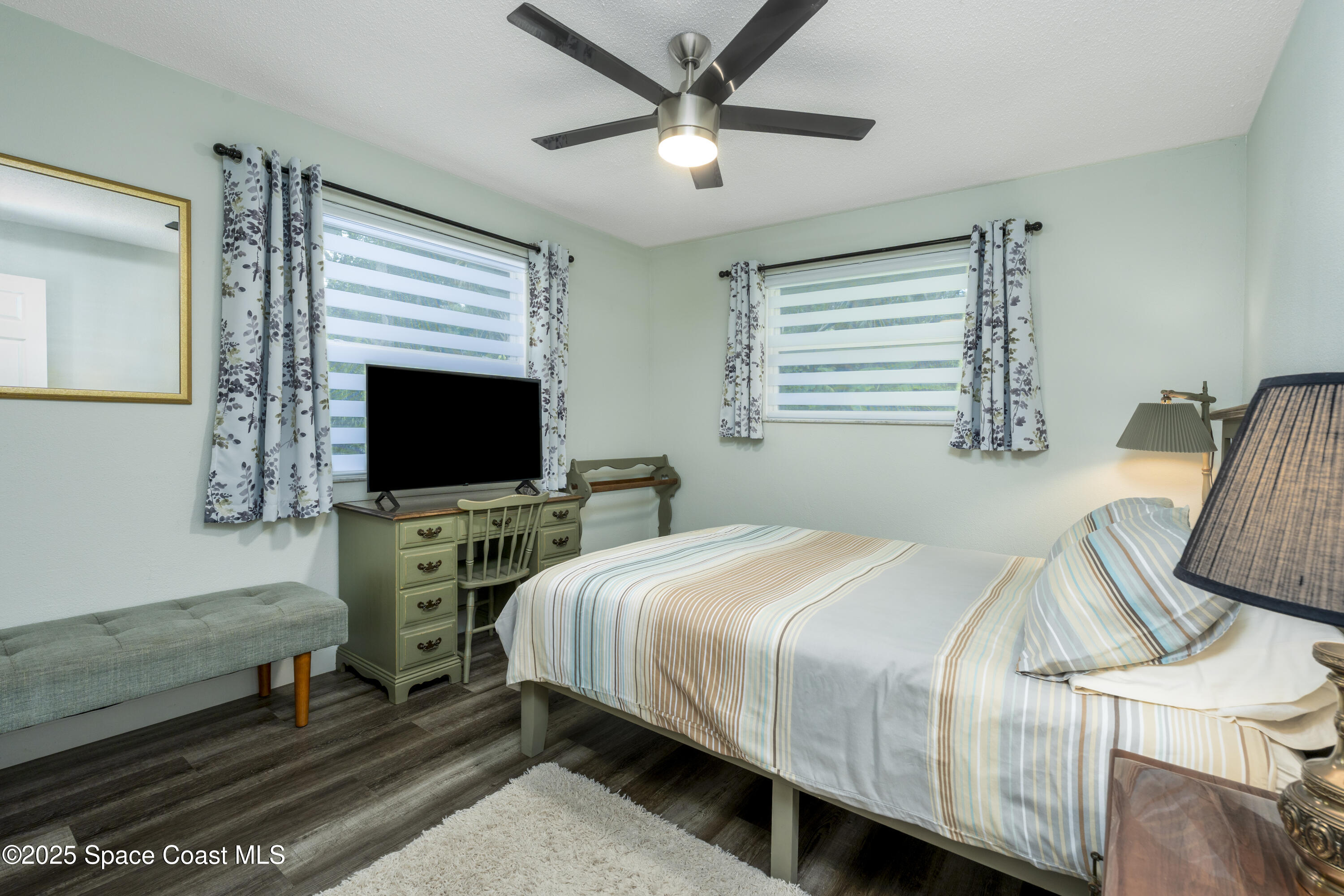 686 Hand Avenue Ormond Beach, FL 32174 - Photo 19 of 29 a bedroom with a bed and a flat screen tv