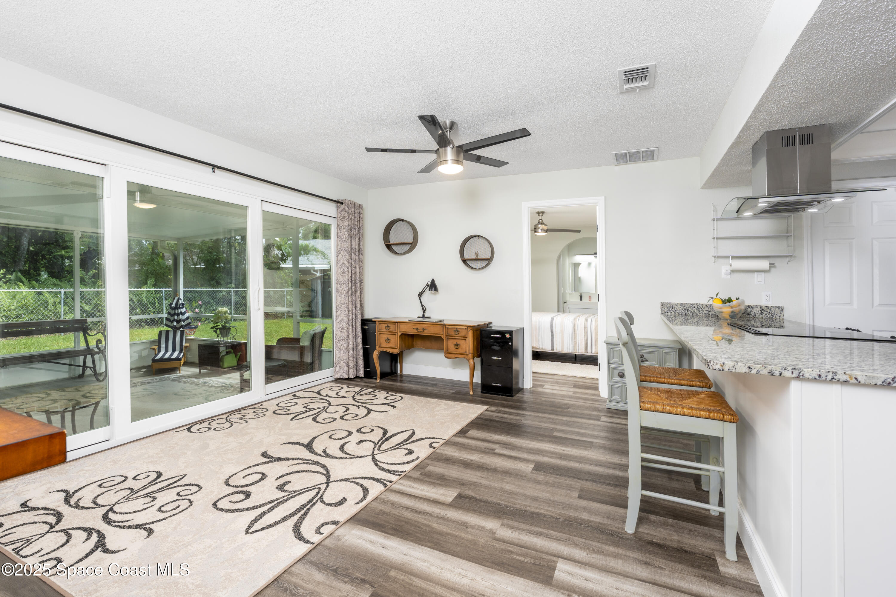 686 Hand Avenue Ormond Beach, FL 32174 - Photo 8 of 29 a living room with furniture and a floor to ceiling window