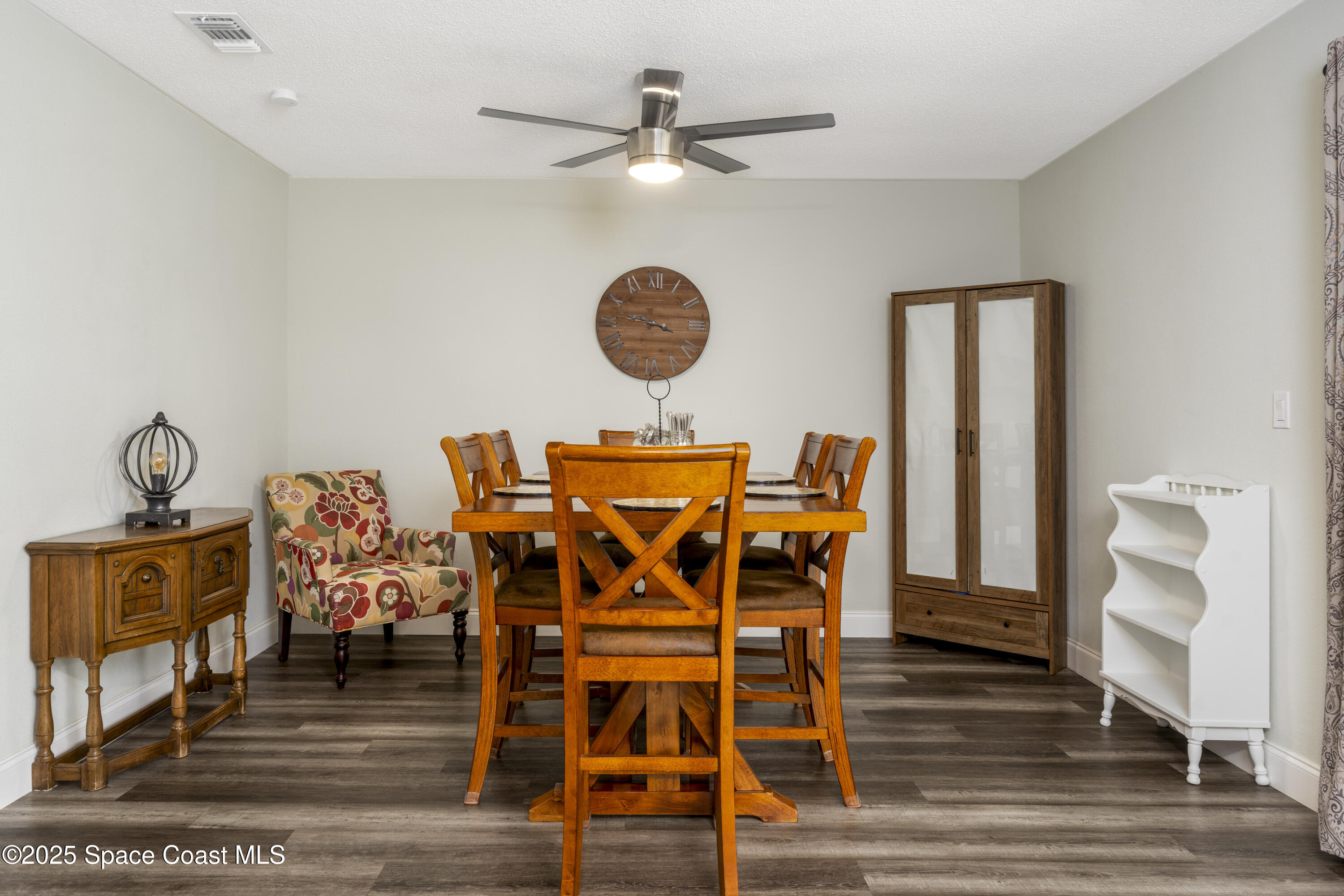 686 Hand Avenue Ormond Beach, FL 32174 - Photo 9 of 29 a view of a dining room with furniture wooden floor and a chandelier