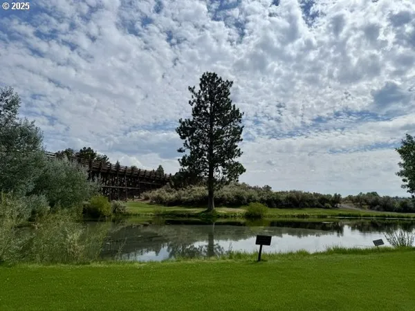 a terrace with a bench and trees