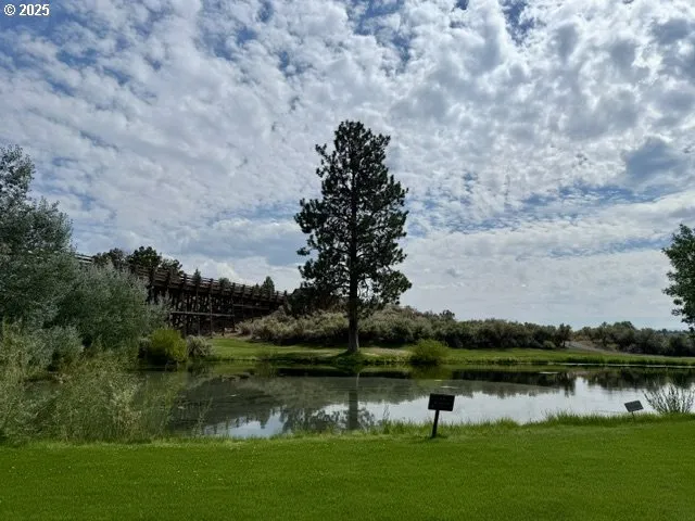 a terrace with a bench and trees