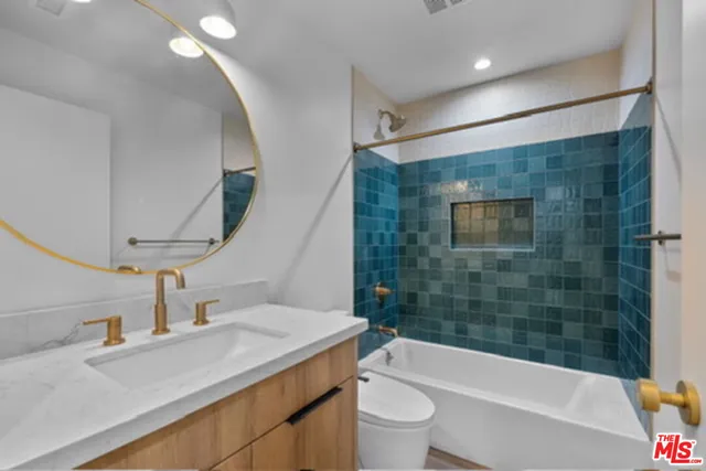 a bathroom with a sink a toilet and bathtub
