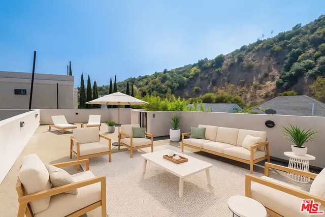 a terrace of a house with outdoor seating