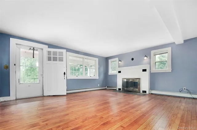 an empty room with furniture and a fireplace