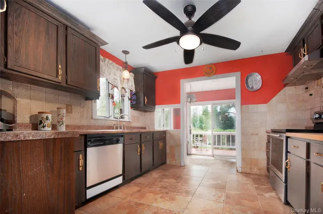 a kitchen with stainless steel appliances granite countertop a stove and a sink