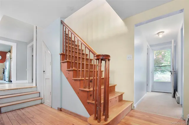 a view of entryway and hall with wooden floor