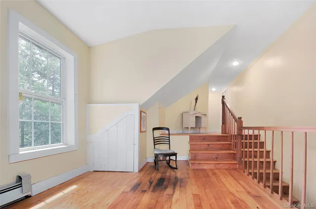 a view of entryway with wooden floor and stairs