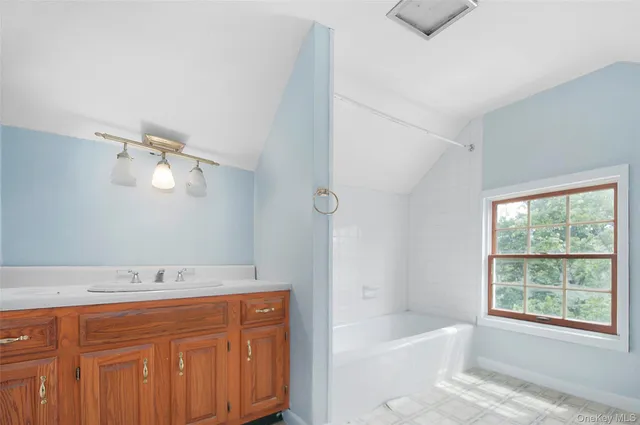 a bathroom with a granite countertop sink a toilet and shower