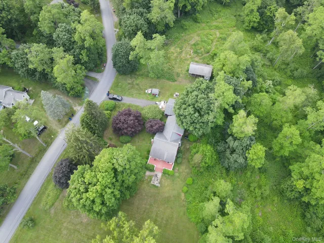 an aerial view of a house with a yard