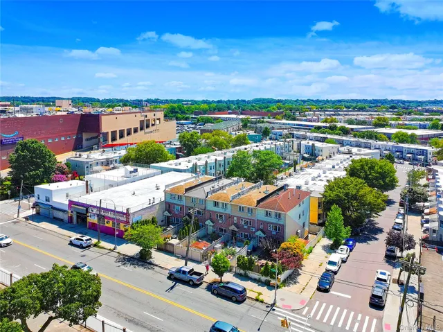 an aerial view of multiple houses with yard