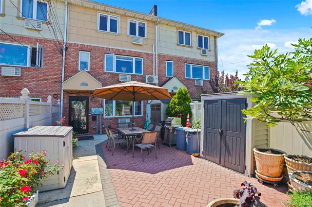 a view of a patio with a table and chairs under an umbrella