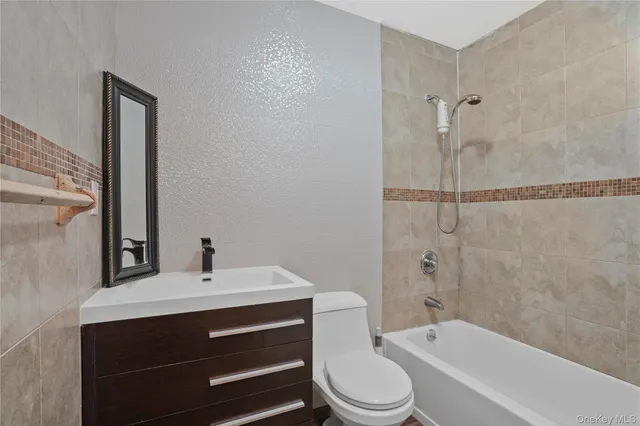 a bathroom with a sink toilet a mirror and shower