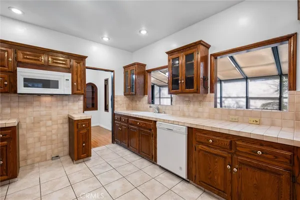 a kitchen with stainless steel appliances granite countertop a stove sink and cabinets