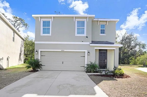 a view of a house with a yard and garage