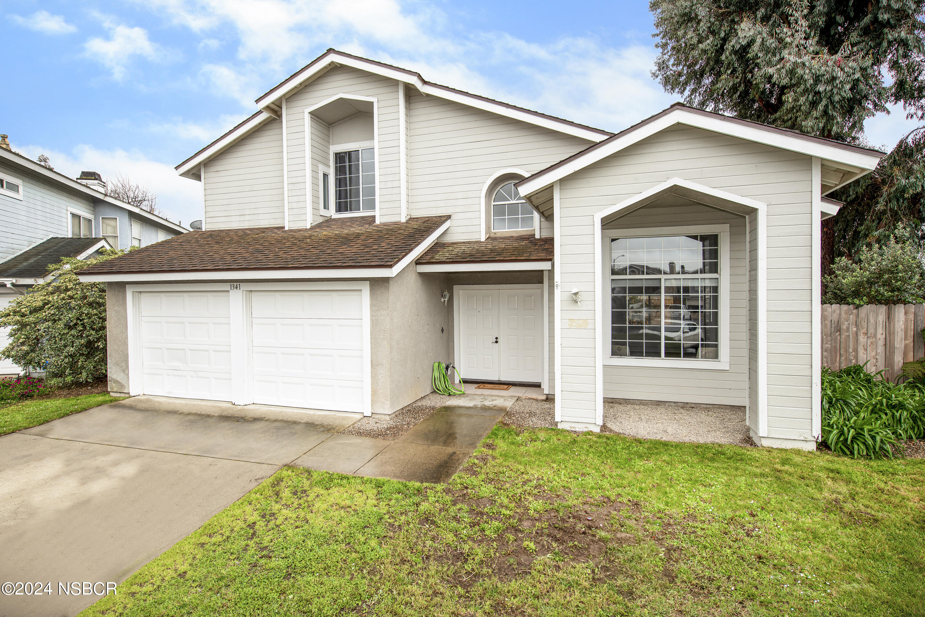1341 Lloyd Place Lompoc, CA 93436 - Photo 1 of 20 a view of a house with yard and garage