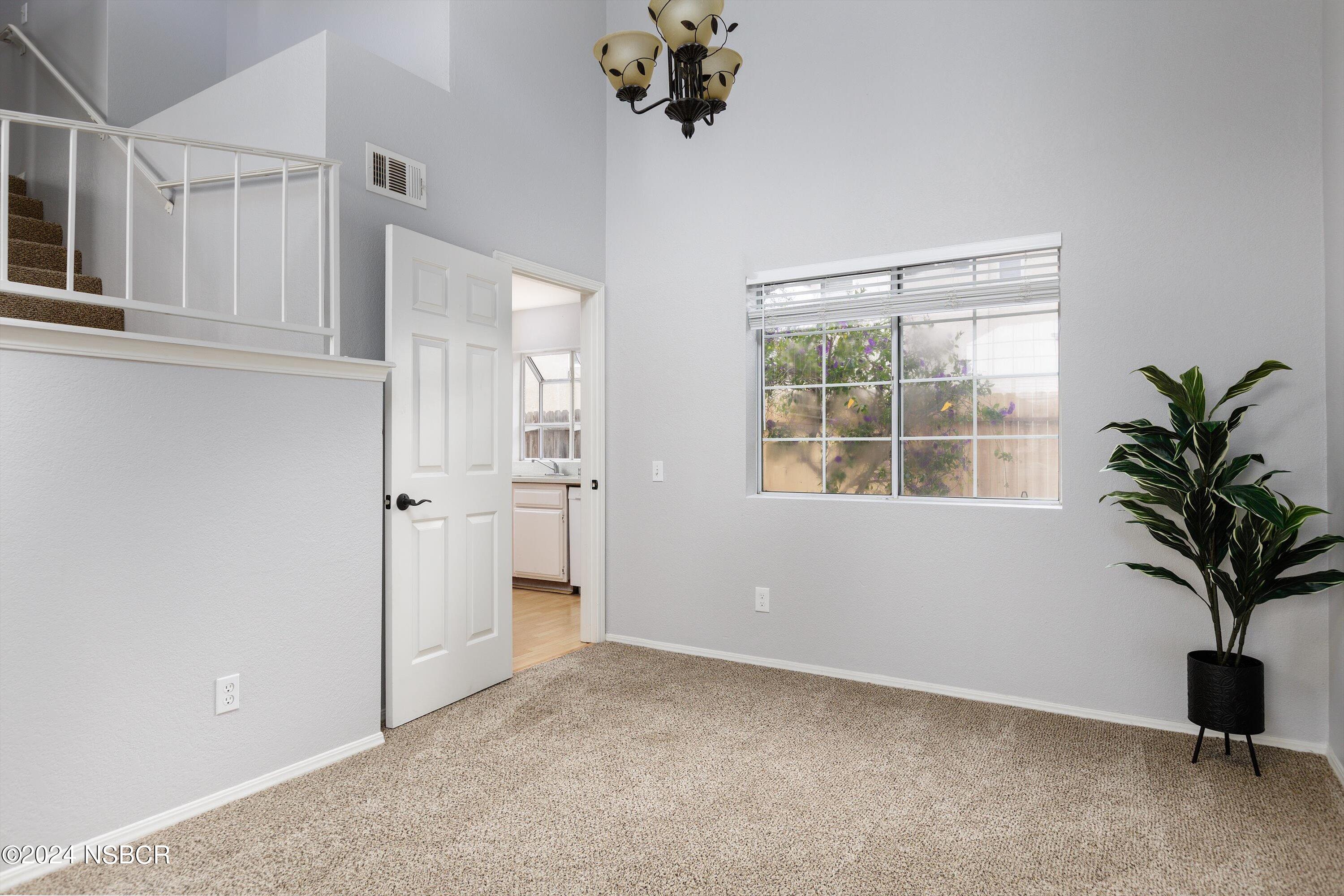 1341 Lloyd Place Lompoc, CA 93436 - Photo 5 of 20 an empty room with windows and flower pot