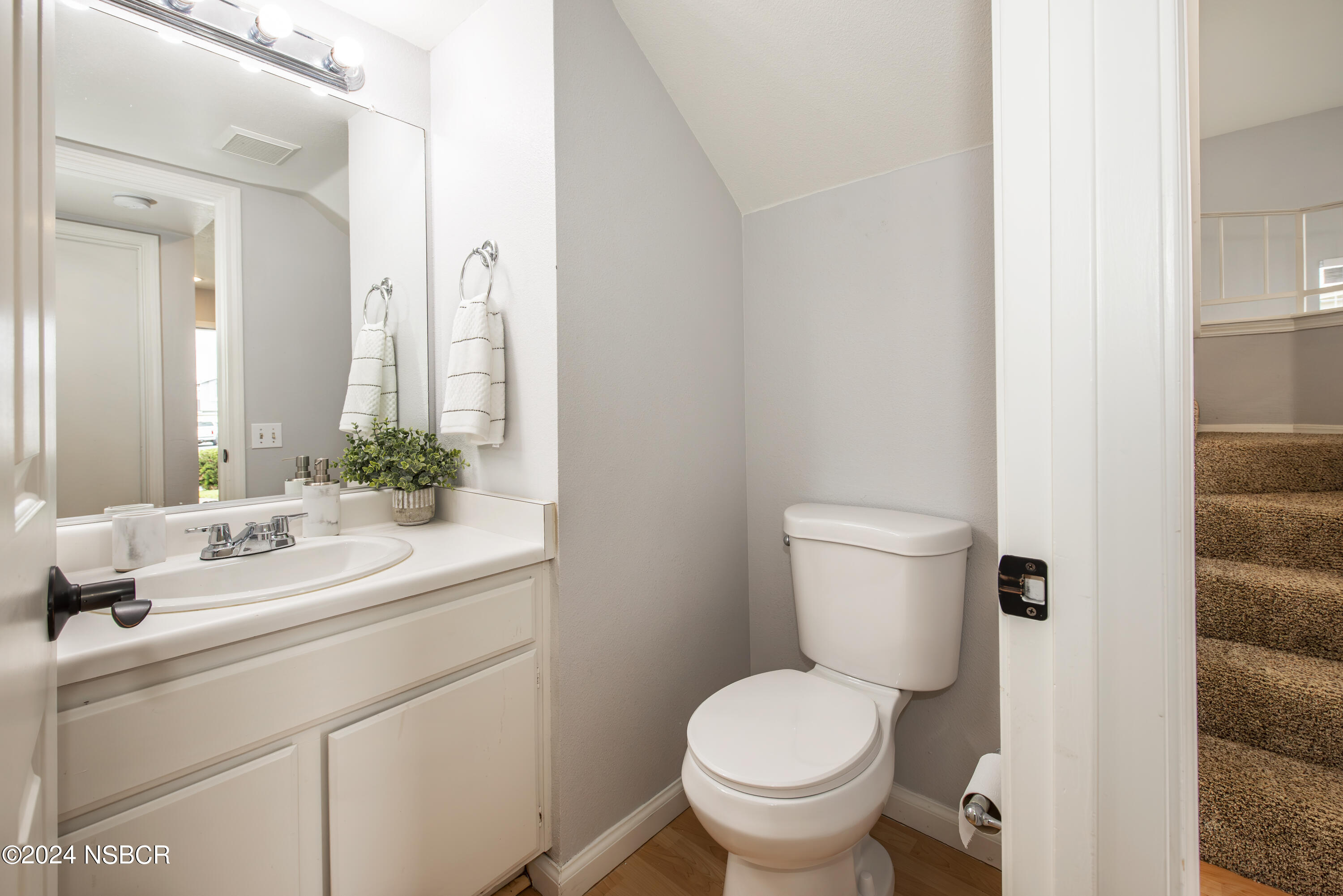 1341 Lloyd Place Lompoc, CA 93436 - Photo 10 of 20 a bathroom with a toilet sink and mirror