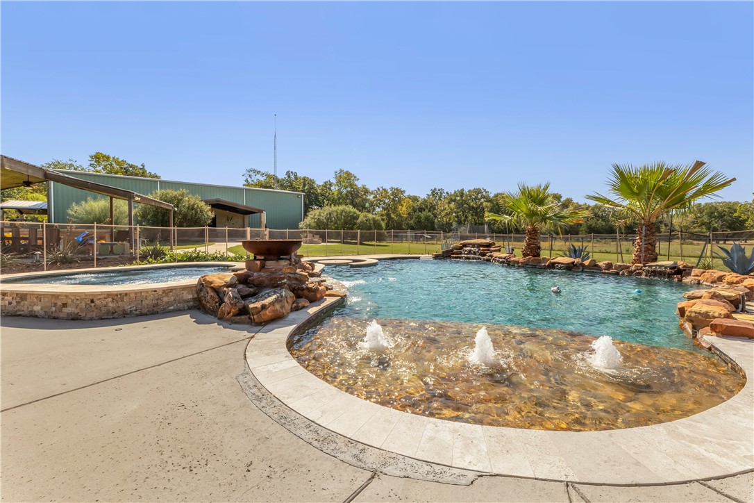 10285 Ferrill Creek Road Bryan, TX 77808 - Photo 14 of 49 a view of a swimming pool and a yard