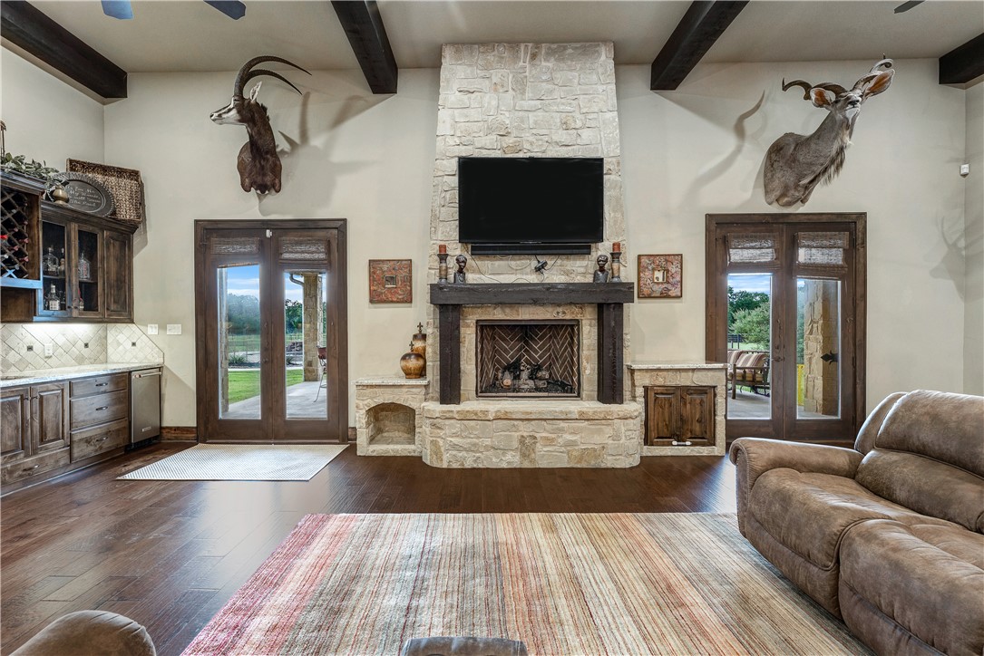 10285 Ferrill Creek Road Bryan, TX 77808 - Photo 21 of 49 a living room with furniture flat screen tv and a fireplace