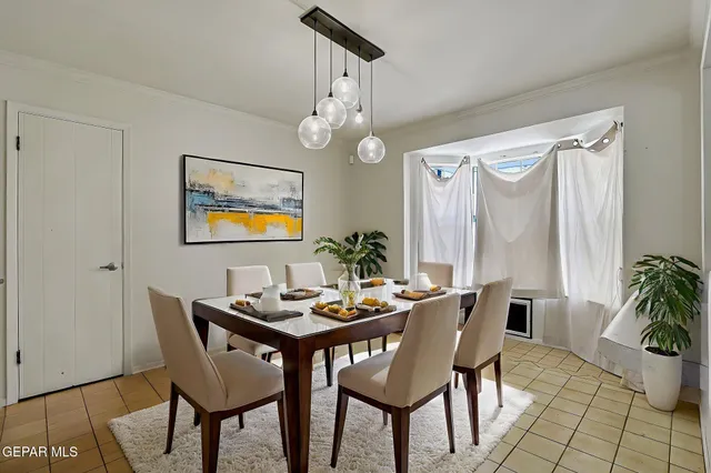 a dining room with furniture potted plants and wooden floor