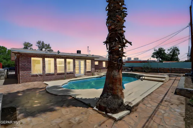 a view of a swimming pool with a yard