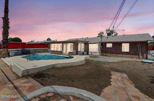 a front view of a house with a garden and yard