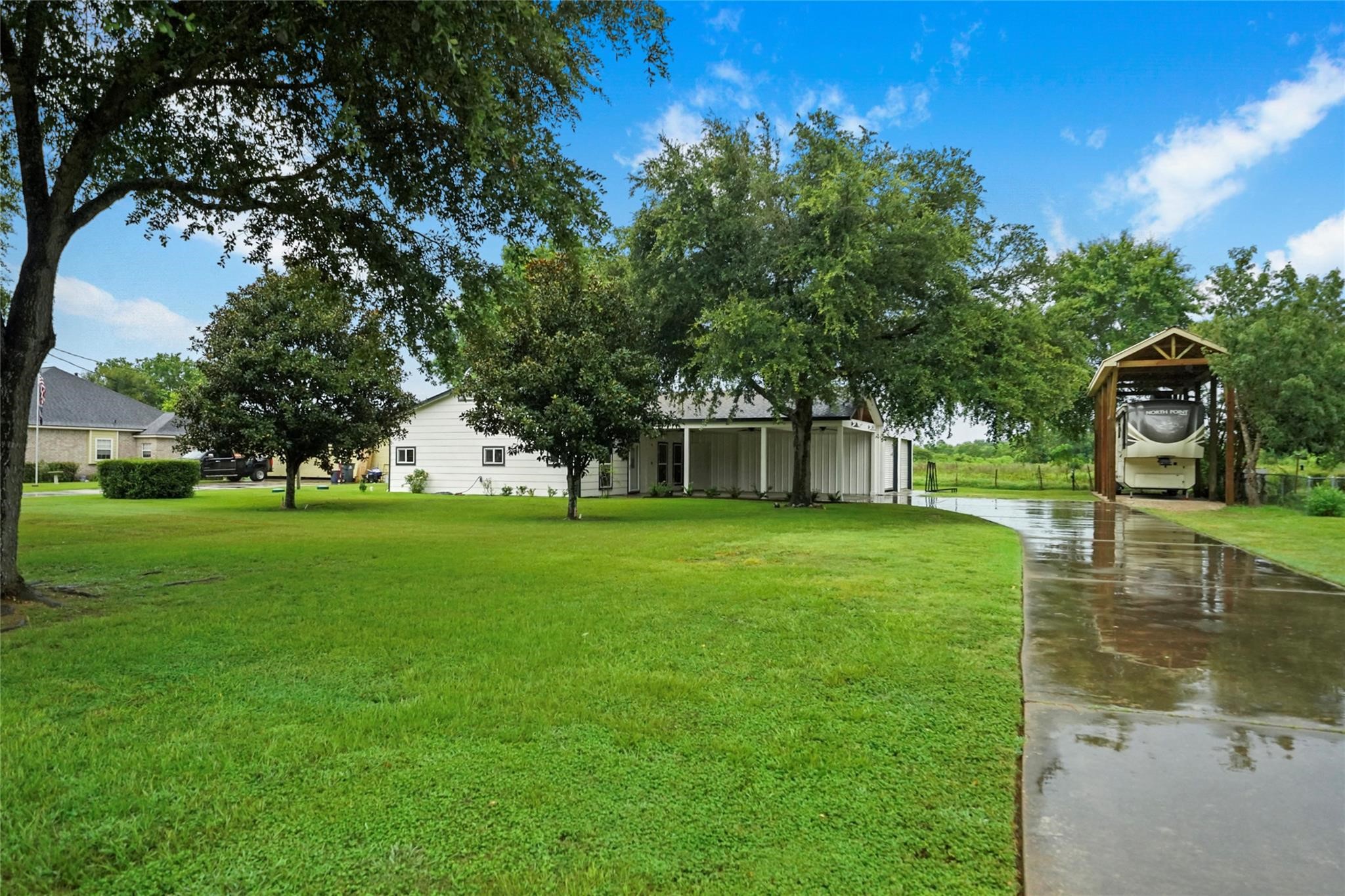 30720 Waller Spring Creek Road Waller, TX 77484 - Photo 2 of 22 Enjoy the charm of this lovely home with covered RV parking, electric hookup, and plenty of room to roam on a picturesque 0.4-acre lot.