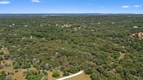 a view of a city with lush green forest