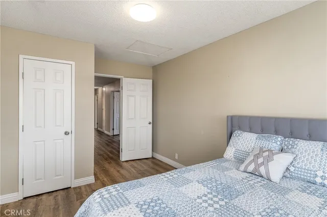 a bedroom with a bed and wooden floor