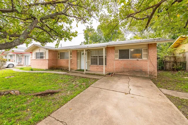 a view of backyard of house with green space