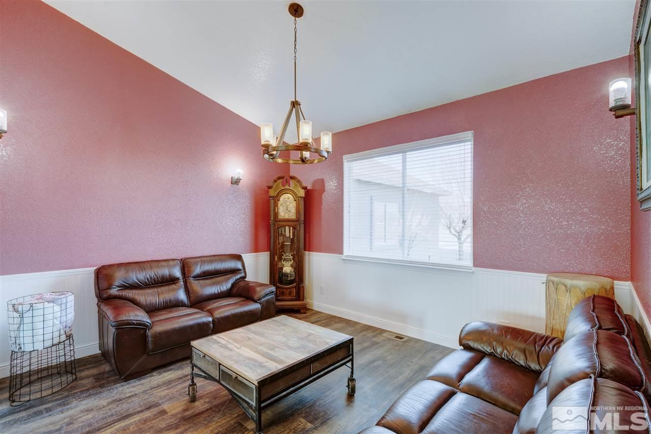 4925 Rancheria Road Fallon, NV 89406 - Photo 13 of 39 a living room with furniture a chandelier and a window