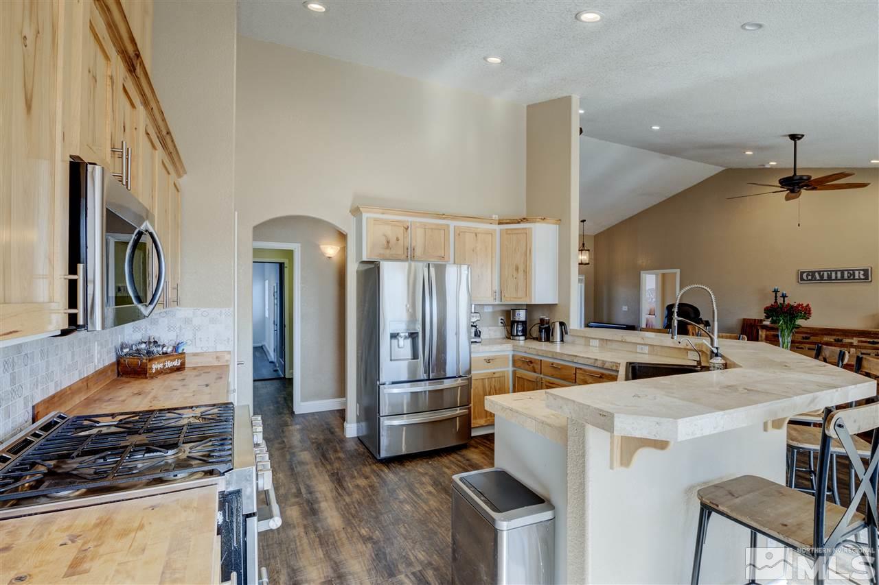 4925 Rancheria Road Fallon, NV 89406 - Photo 14 of 39 a kitchen with a stove a refrigerator and a stove top oven
