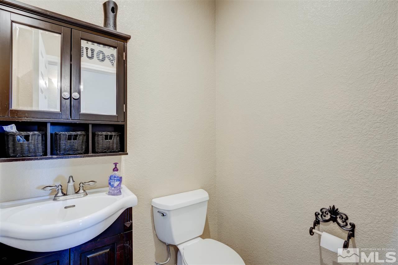 4925 Rancheria Road Fallon, NV 89406 - Photo 24 of 39 a bathroom with a toilet sink and mirror