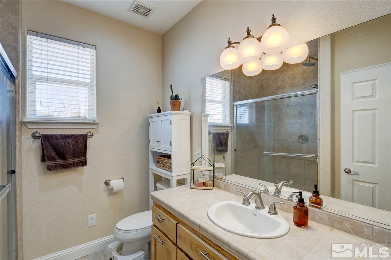 4925 Rancheria Road Fallon, NV 89406 - Photo 26 of 39 a bathroom with a sink a large mirror and a toilet
