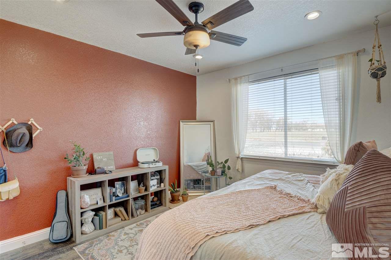 4925 Rancheria Road Fallon, NV 89406 - Photo 27 of 39 a bedroom with a bed and a chandelier